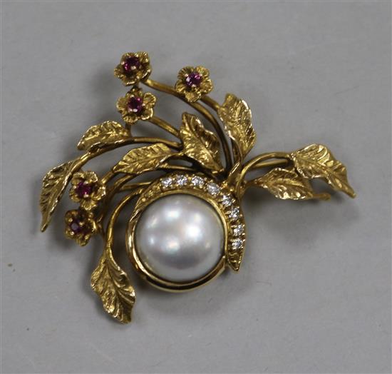 A Givenchy 14ct gold, mabe pearl, ruby and diamond floral spray brooch in Harrods box, 37mm.